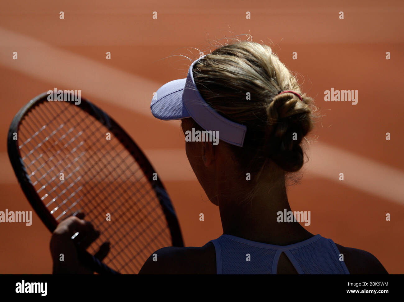 Rearview of tennis player Elena Dementieva RUS) arranging strings in her racket during break of play. Stock Photo