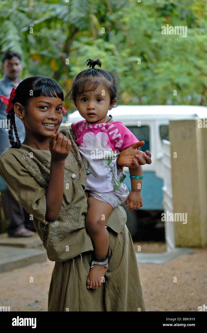 Young woman and child in one of Chennai's many suburban slum areas; India, Tamil Nadu, Chennai (Madras). No releases available. Stock Photo