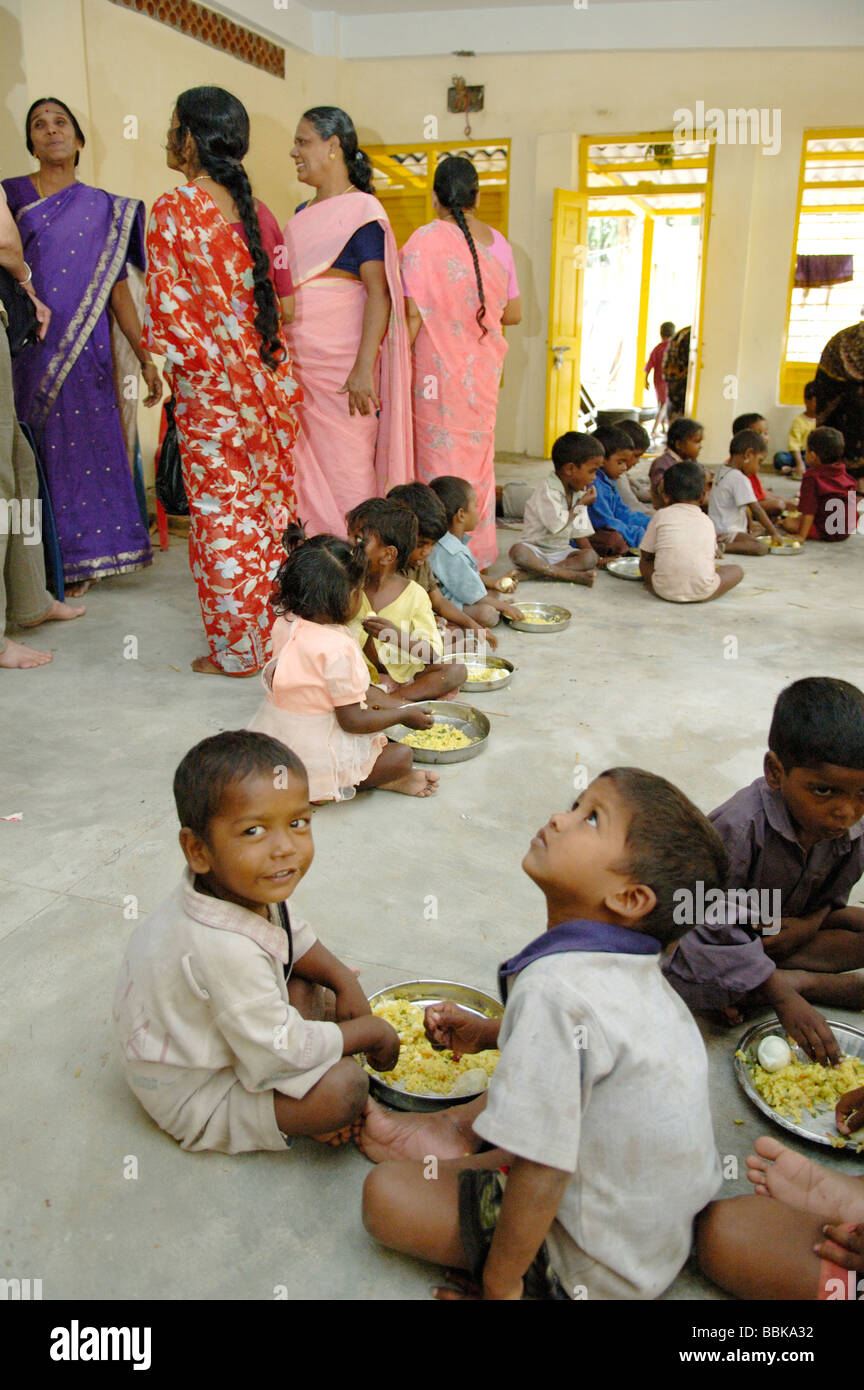 Young children having a meal in one of Chennai's suburban slum playschools; India, Tamil Nadu, Chennai (Madras) ... Stock Photo