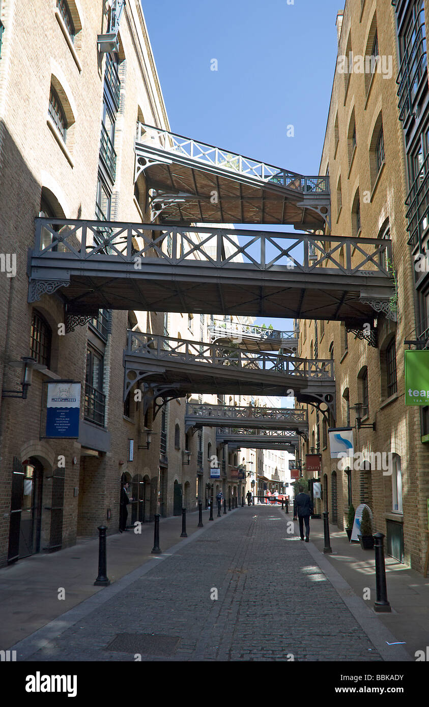 london wharf warehouses with walkways spanning the street Stock Photo