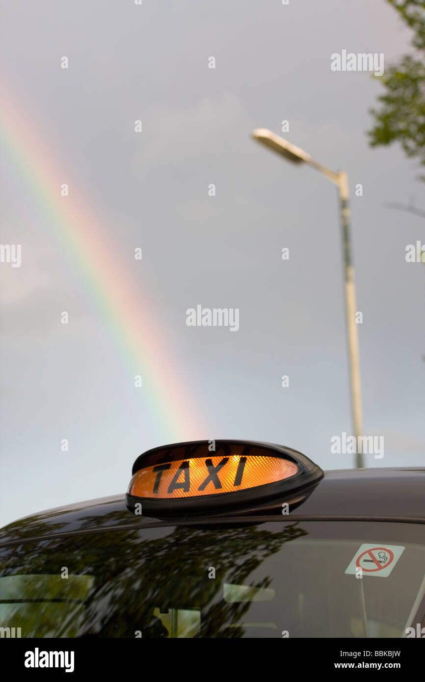 London Black Taxi Cab and Rainbow Stock Photo