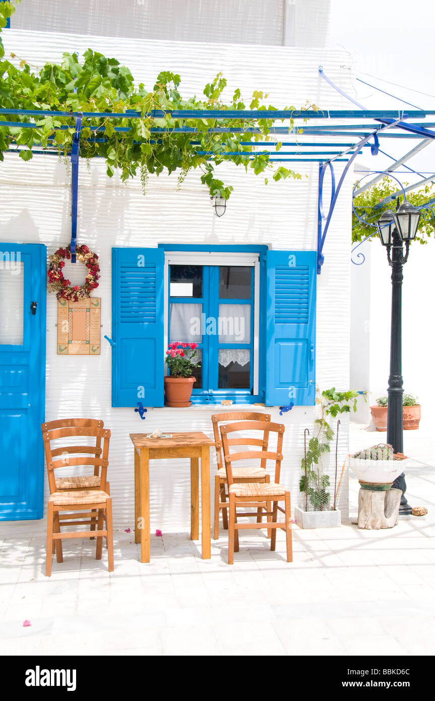 outdoor cafe setting with typical greek furniture chairs and generic architecture in the greek islands village of lefkes paros Stock Photo