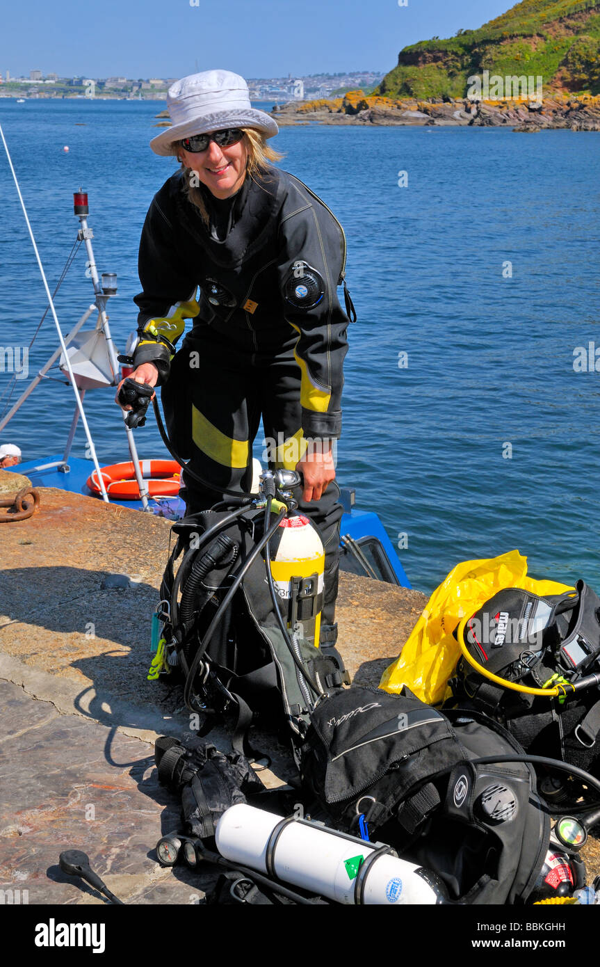 Woman scuba diver preparing dive kit on quayside Fort Bovisand Plymouth UK Stock Photo