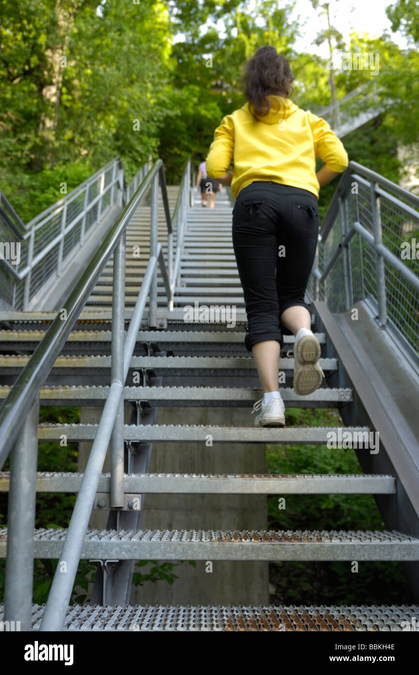 Woman climbing up the stairs Stock Photo Alamy