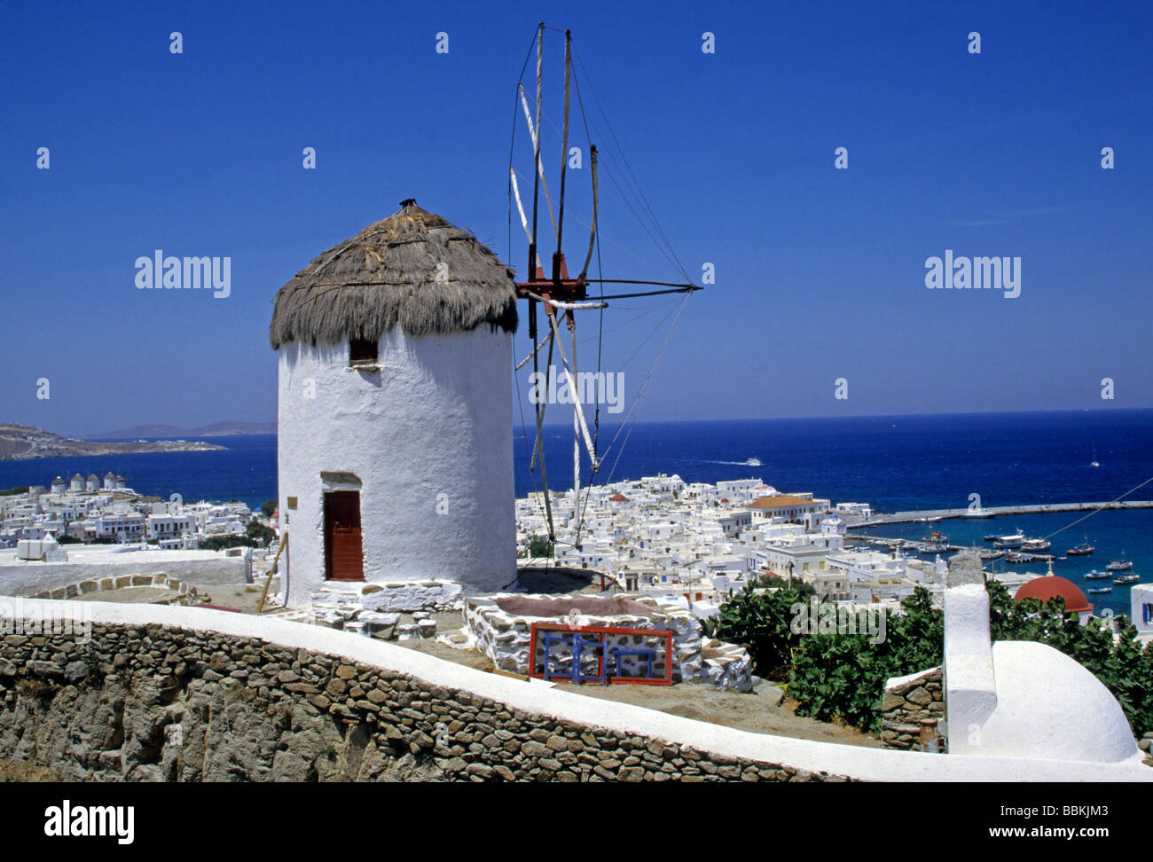 Windmill overlooking the town and harbor, Mykonos, Cyclades, Greece Stock Photo
