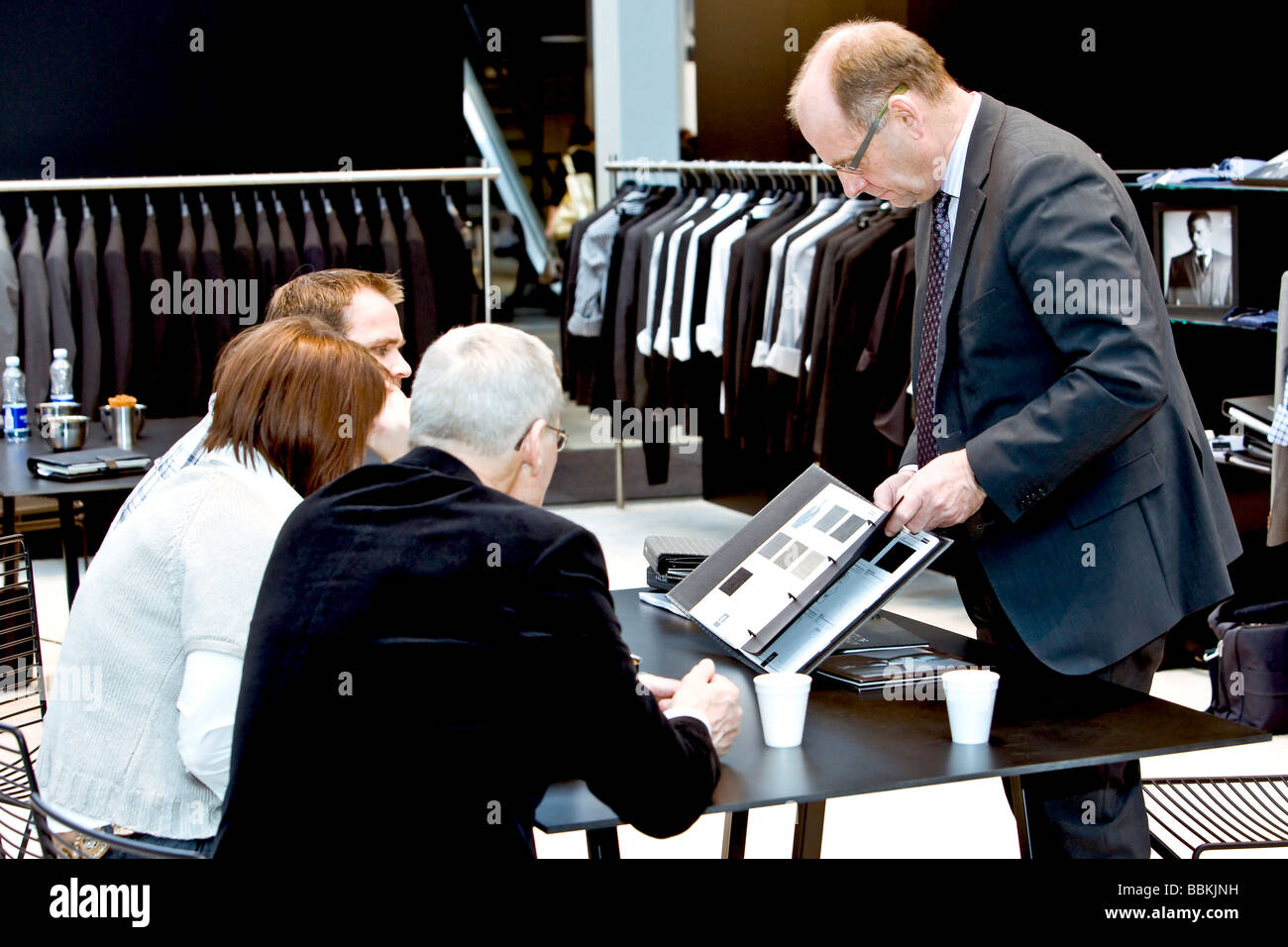 Four people negotiating sales contract Stock Photo