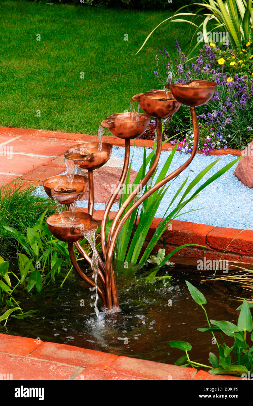 MODERN WATER FEATURE INCORPORATING COPPER CUP CASCADE AND BROKEN GLASS MULCH Stock Photo Alamy