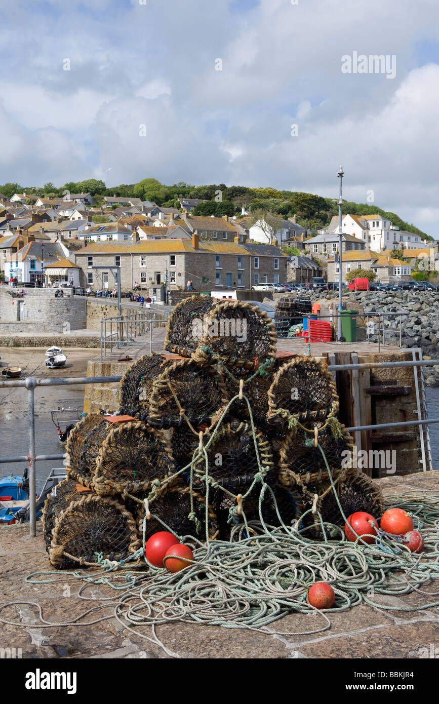 Mousehole harbour side and lobster pots Stock Photo
