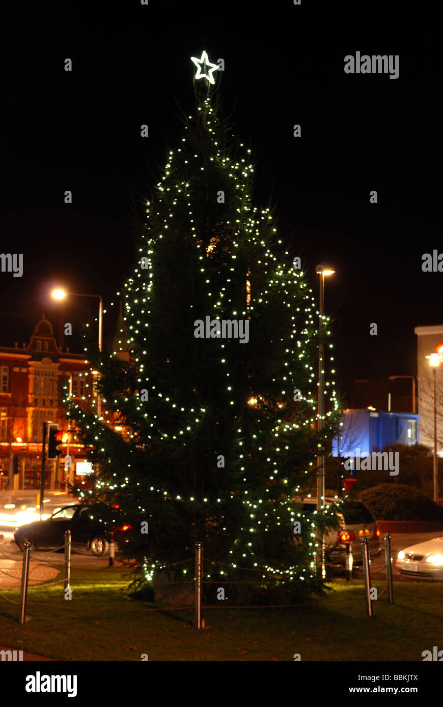 CHRISTMAS DECORATIONS ON CHRISTMAS TREE IN WANSTEAD VILLAGE LONDON PHOTOGRAPHED AT NIGHT Stock Photo