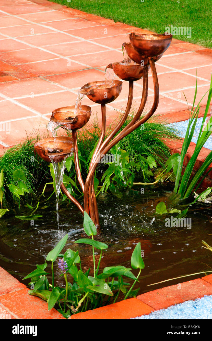 MODERN WATER FEATURE INCORPORATING COPPER CUP CASCADE AND BROKEN GLASS MULCH Stock Photo Alamy