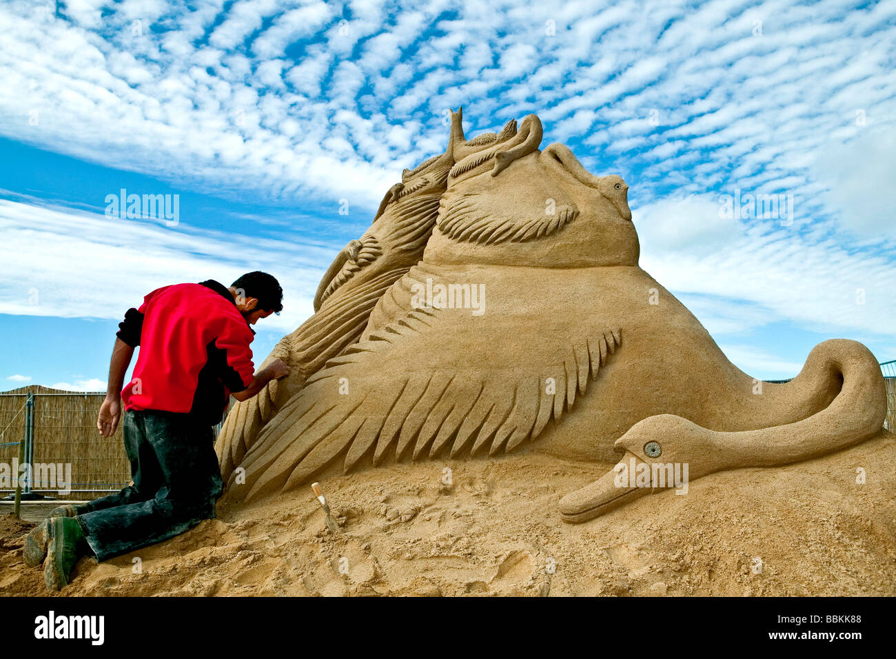 Man creating a sand sculpture Stock Photo