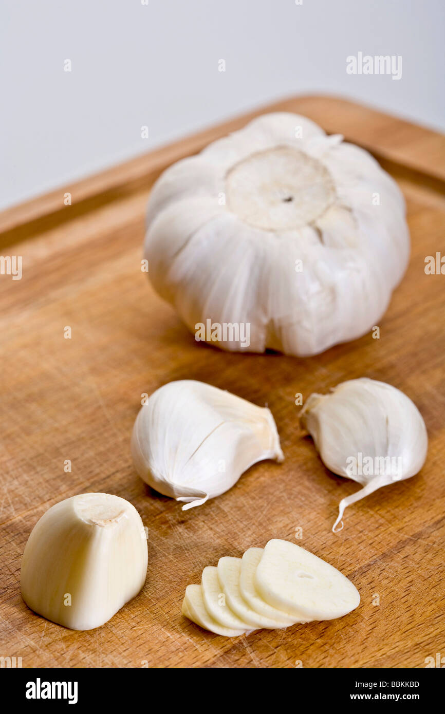 Garlic on carving board Stock Photo