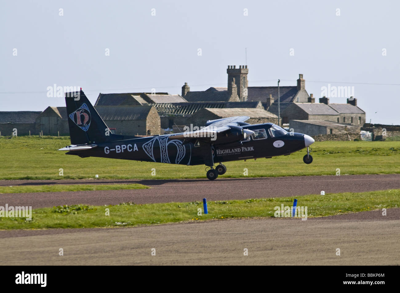 dh Airport NORTH RONALDSAY ORKNEY Loganair Britten Norman Islander airplane landing on airfield runway plane small aircraft turbo prop Stock Photo