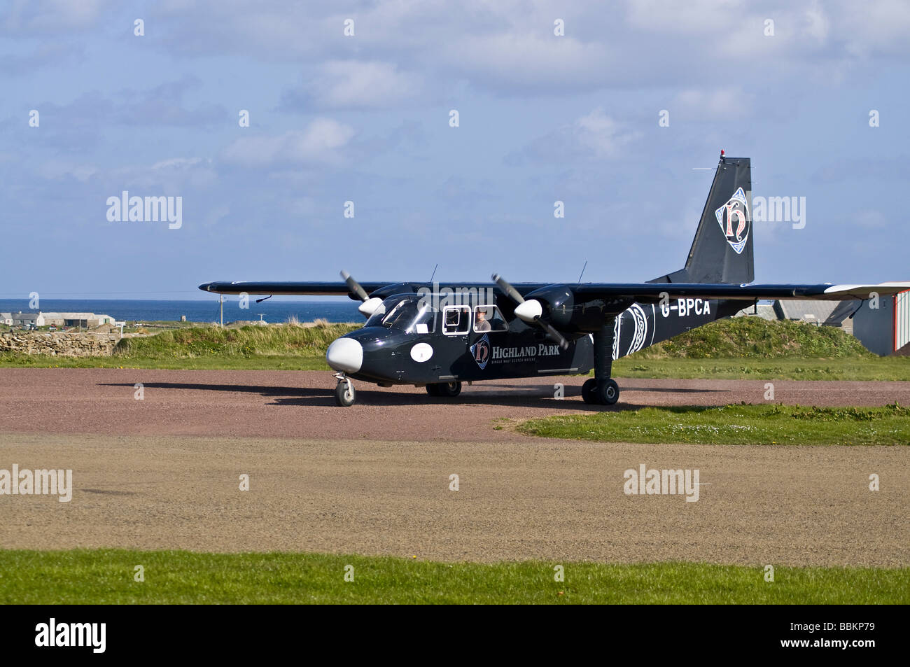 dh  NORTH RONALDSAY ORKNEY Loganair Britten Norman Islander airplane taxiing on airfield runway plane Stock Photo