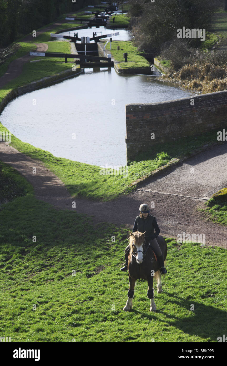 A woman riding a horse along the towpath of the Worcester and Birmingham canal at Tardebigge