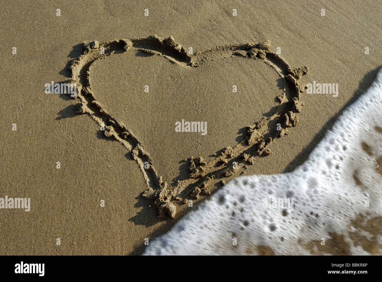 Symbol of a heart drawn in the sand Stock Photo