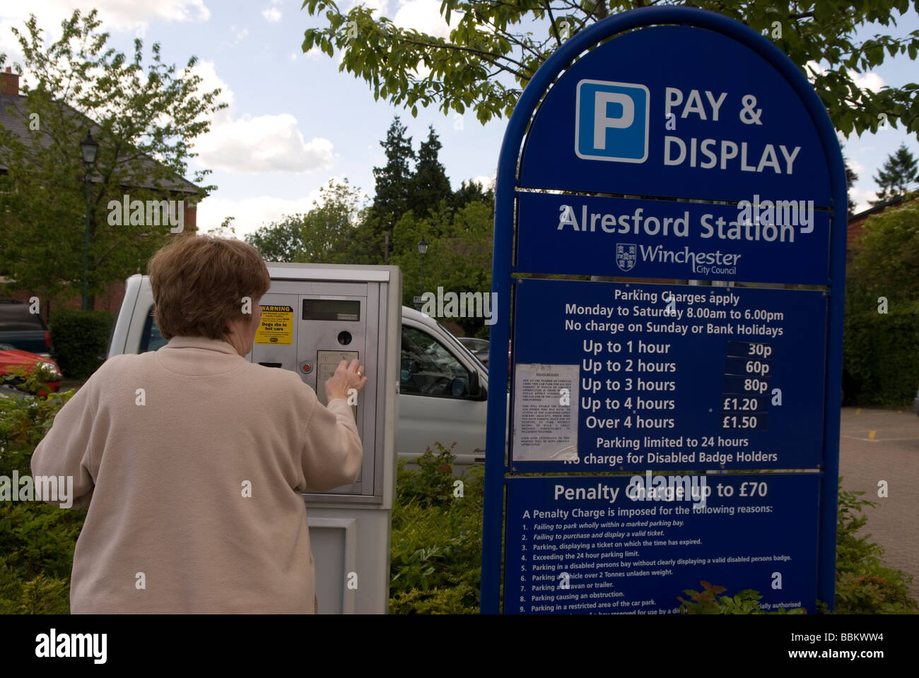 Motorist using pay and display parking machine, Alresford station, Hampshire UK. Stock Photo