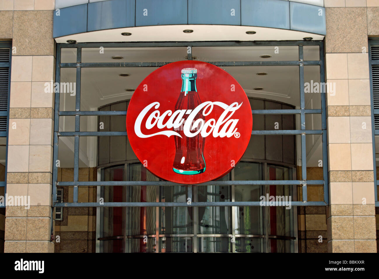 coca cola logo at an entrance to the soft drink company's uk headquarters in hammersmith, west london, england Stock Photo