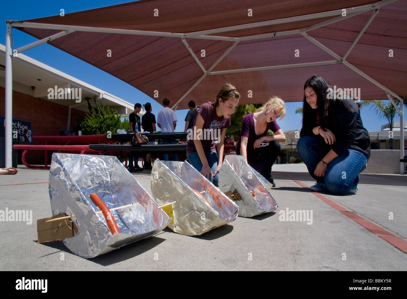 Solar cookers are used by a Southern California high school teacher to demonstrate a use of a parabola in her algebra class. Stock Photo