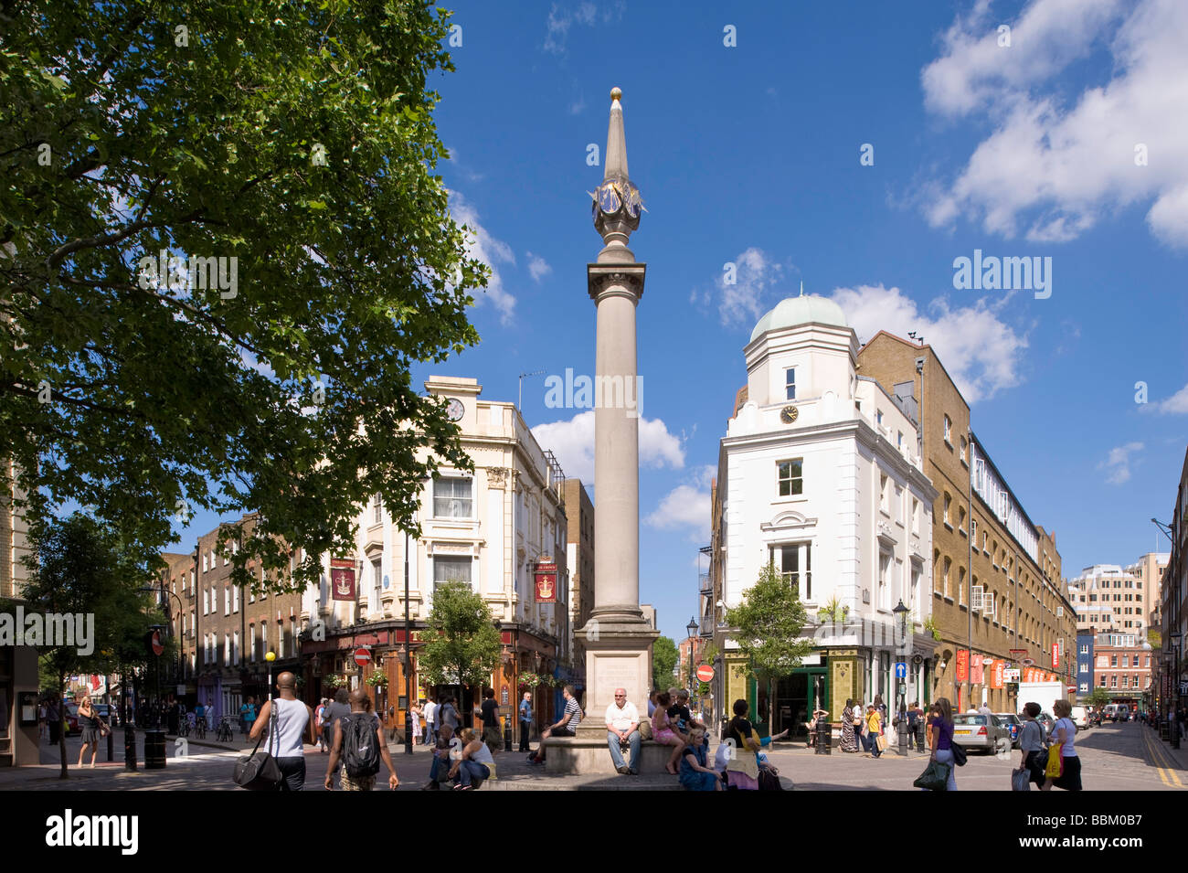 People enjoy warm summer day around Seven Dials West End London United Kingdom Stock Photo