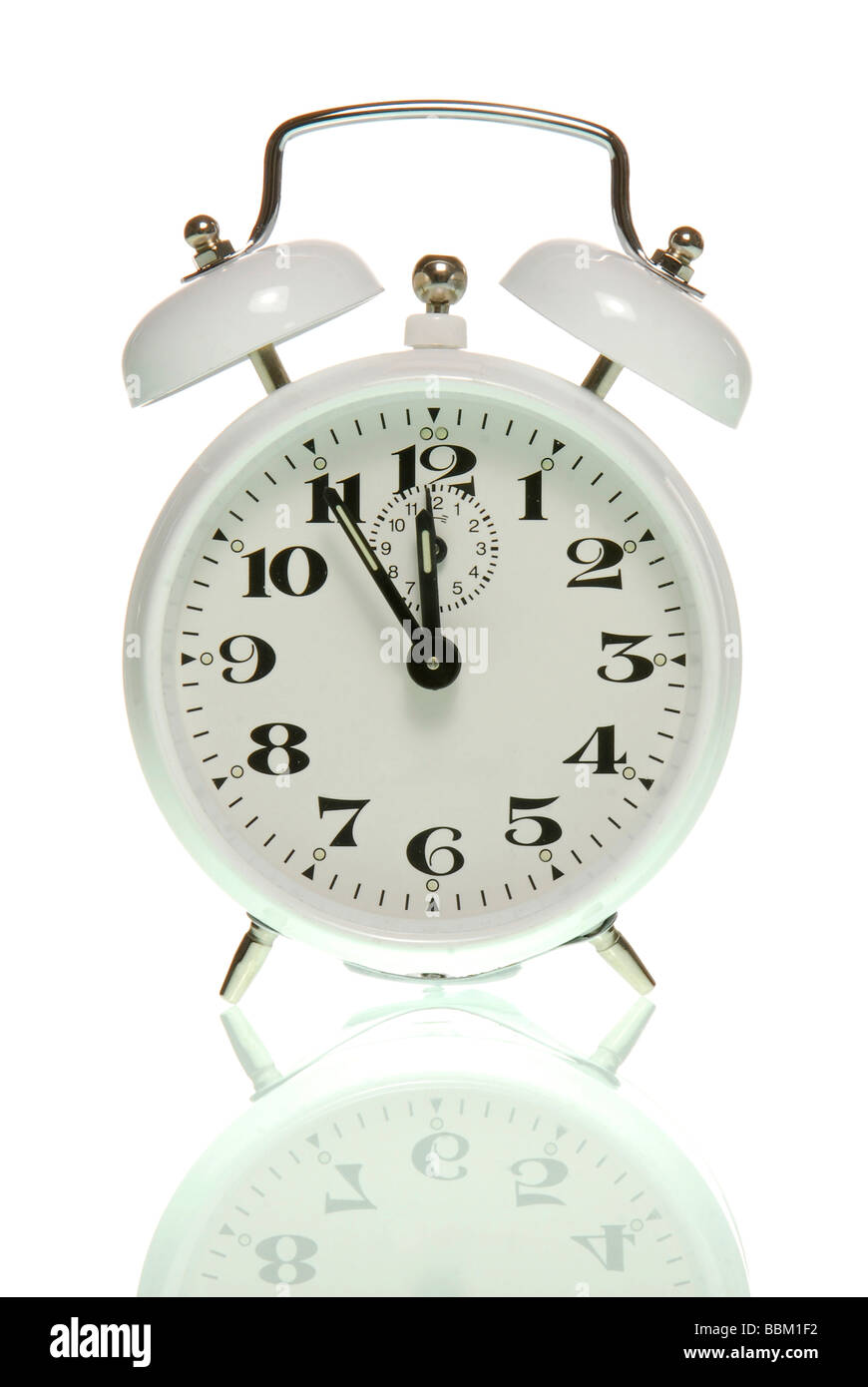 Alarm clock showing five to twelve, symbolic for high time Stock Photo