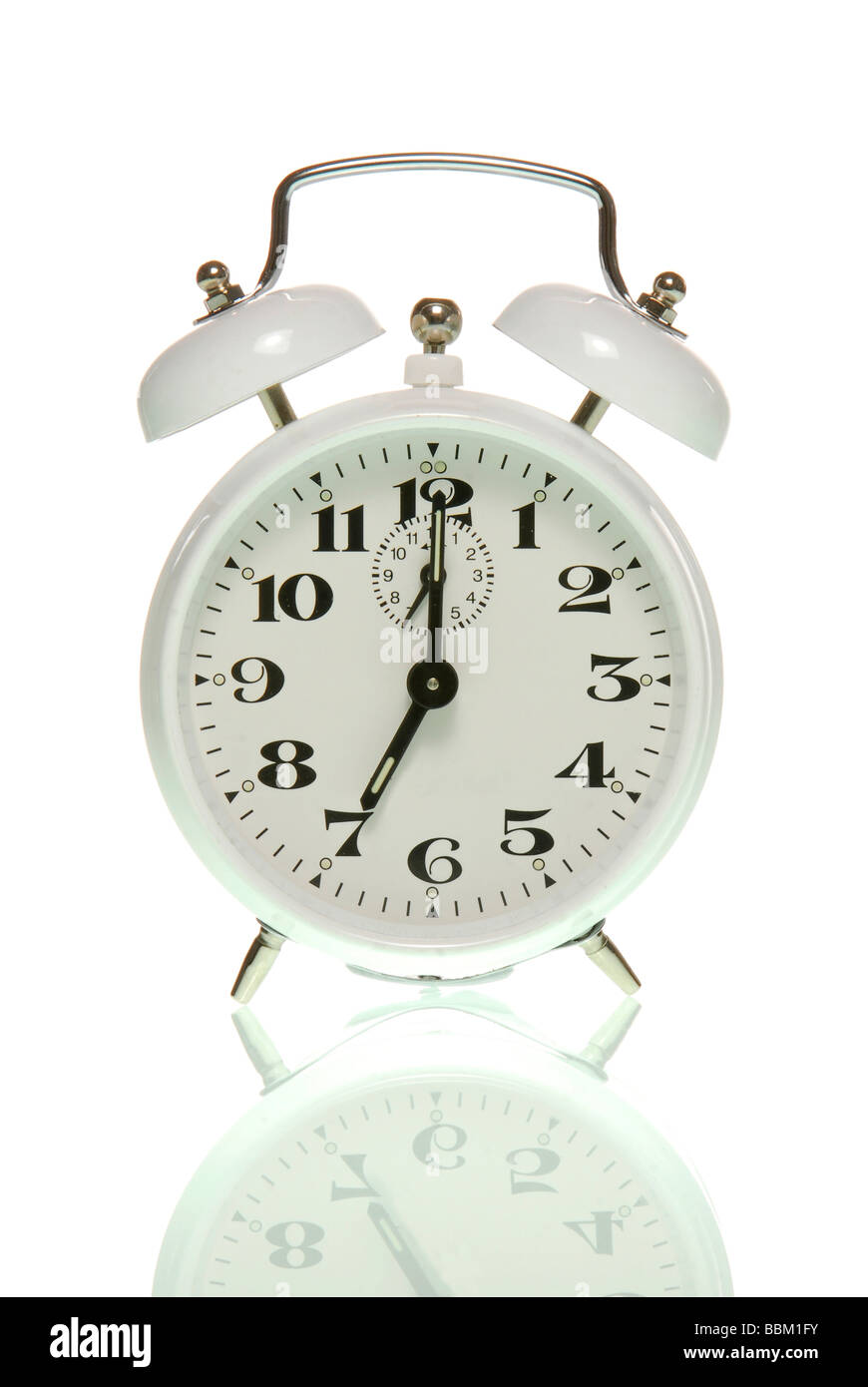 Alarm clock showing seven o'clock Stock Photo