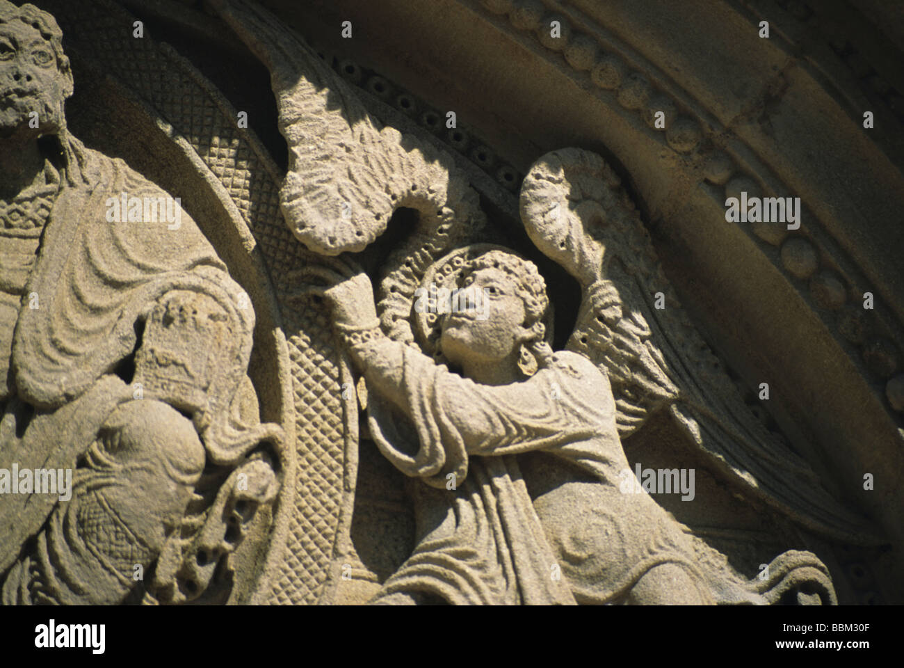 Angel on the tympanum of St Julien en Jonzy, Burgundy. Stock Photo