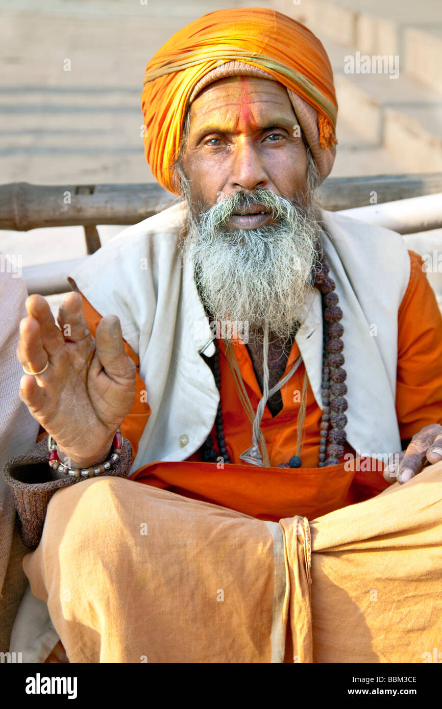 Portait of an elderly Indian beggar man with a grey beard wearing an orange turban, Varanasi, India Stock Photo
