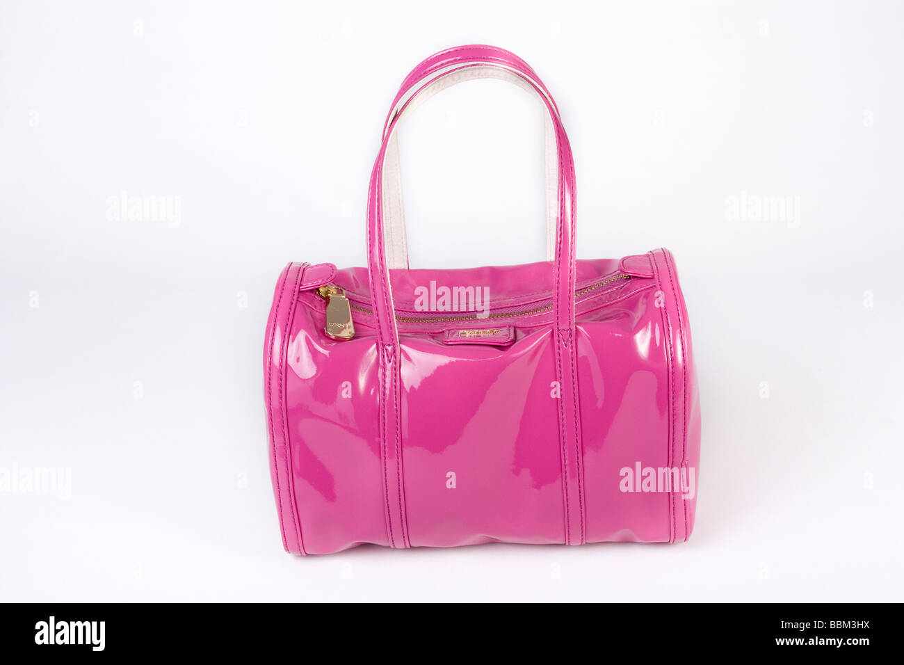 Shiny Pink DKNY ladies handbag studio cut out against white background Stock Photo