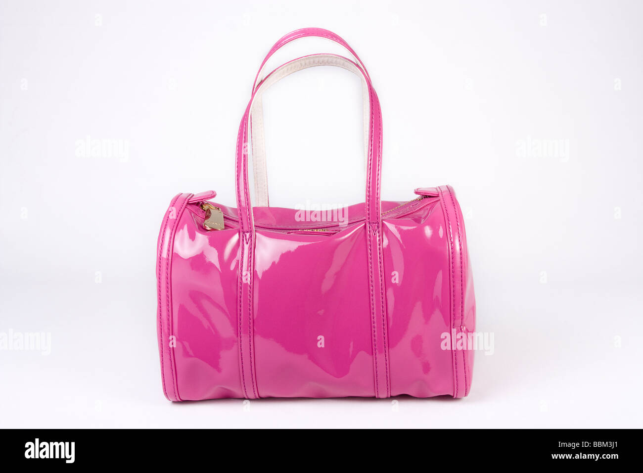 shiny pink dkny ladies handbag studio cut out against white background BBM3J1