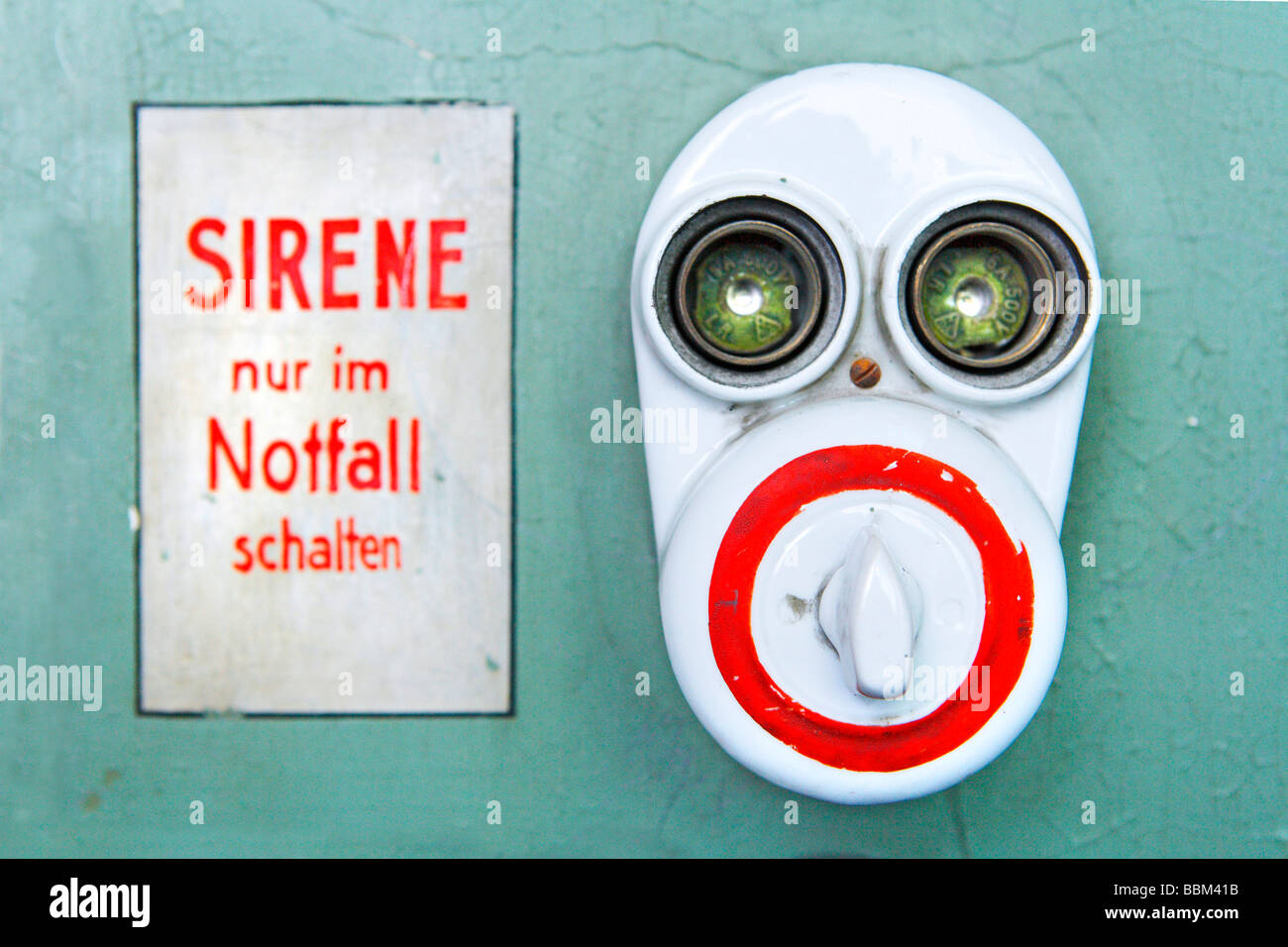 Sirene nur im Notfall schalten, German for Operate siren only in emergency, face, switch, electric switch, fuse, old, historic Stock Photo