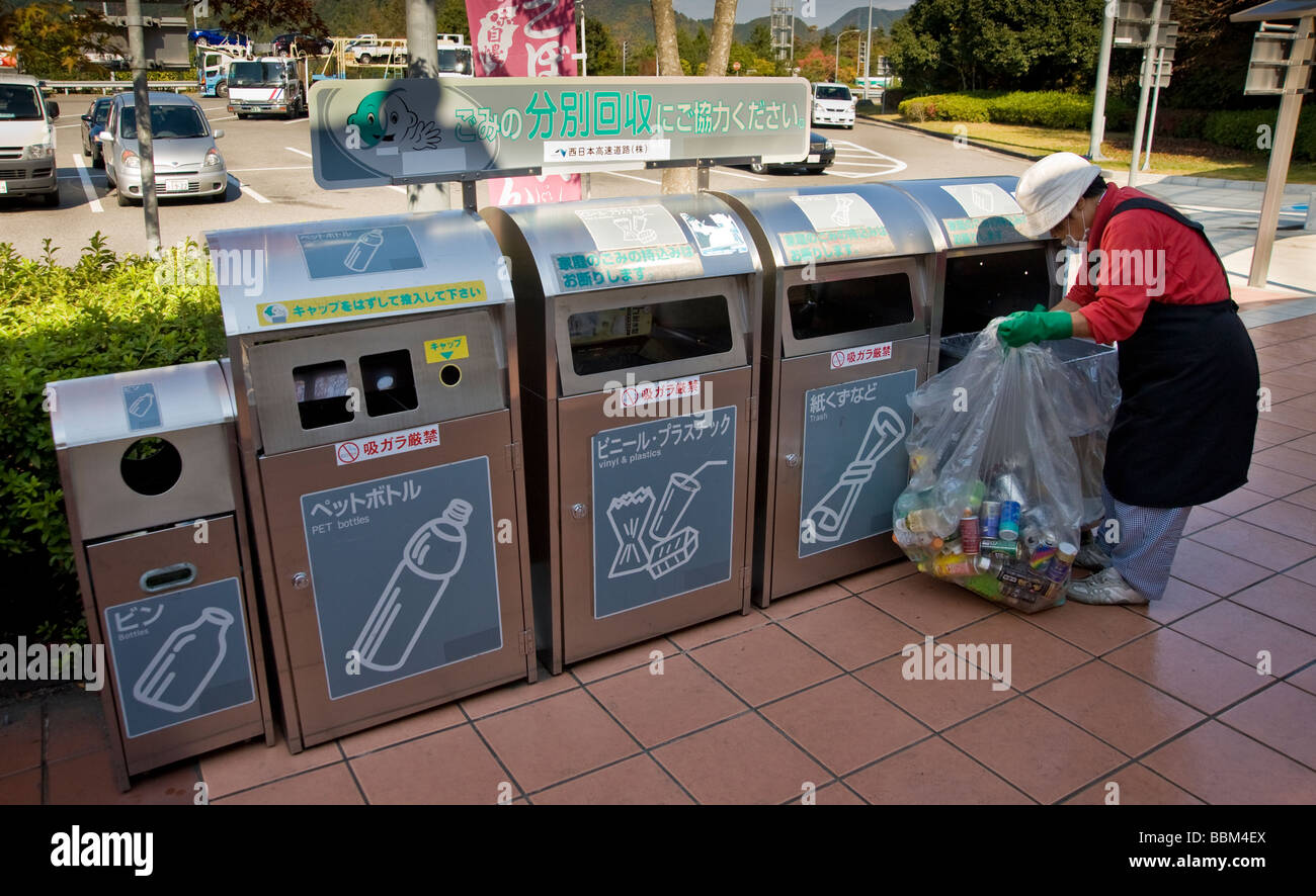 A worker empties recycling bins at Kuchi rest area Jidosha do Hiroshima Prefecture Hiroshima