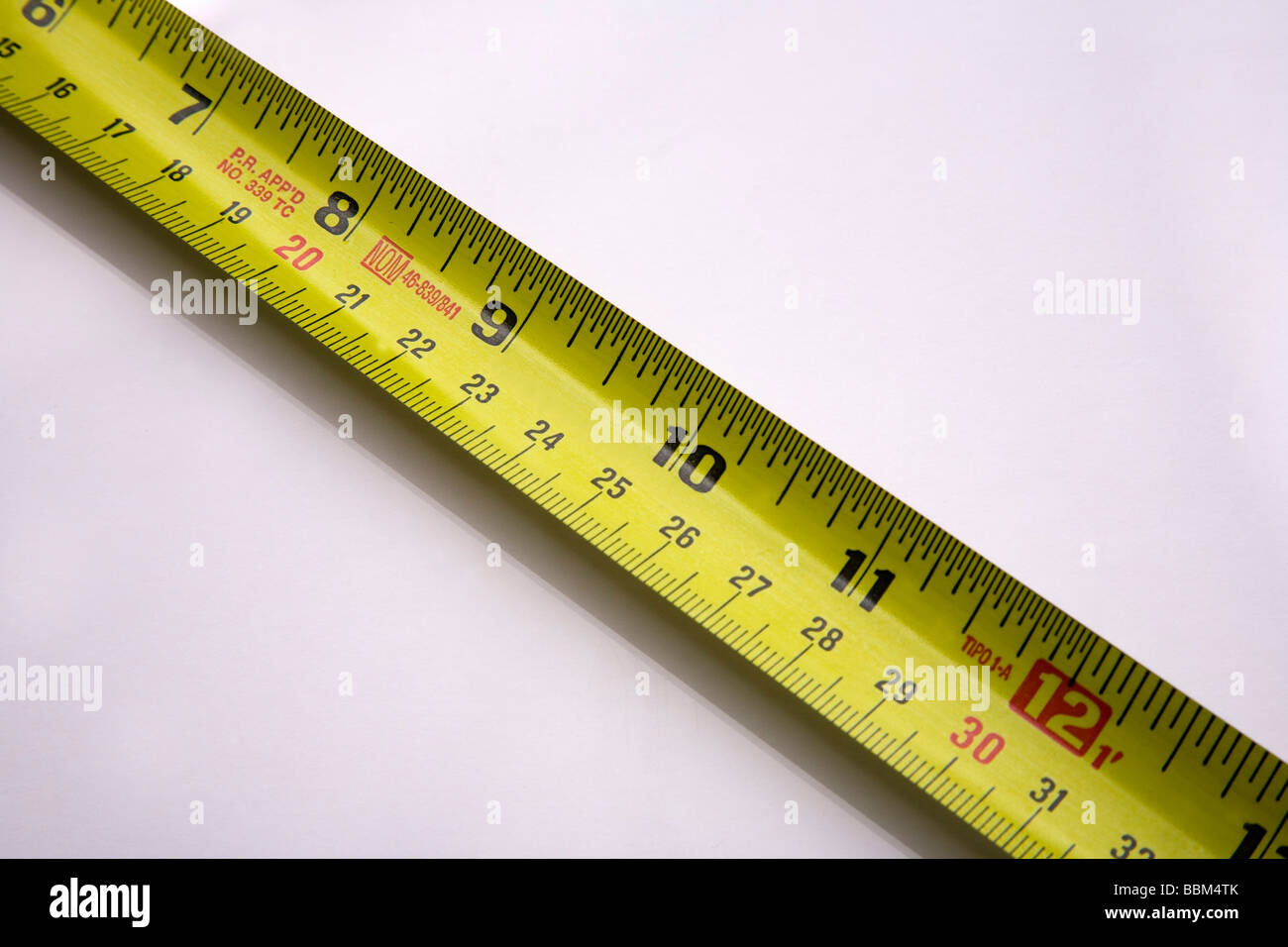 Studio close up shot of extended tape measure showing metric and imperial measurement Stock Photo