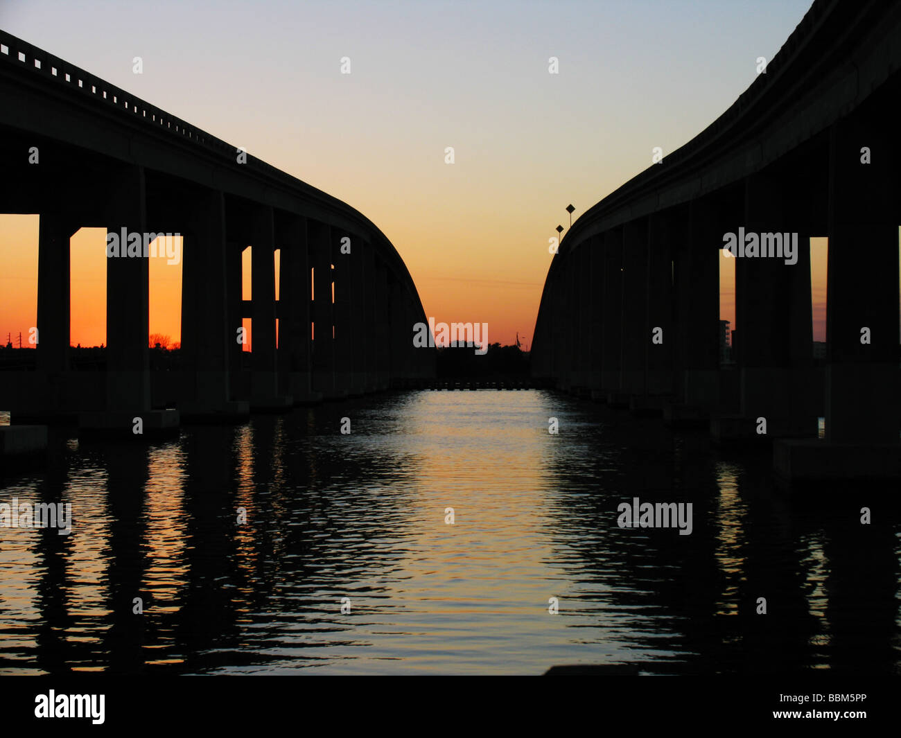 Expressway bridges across river in Florida, scenic, sunset, silouette. Stock Photo