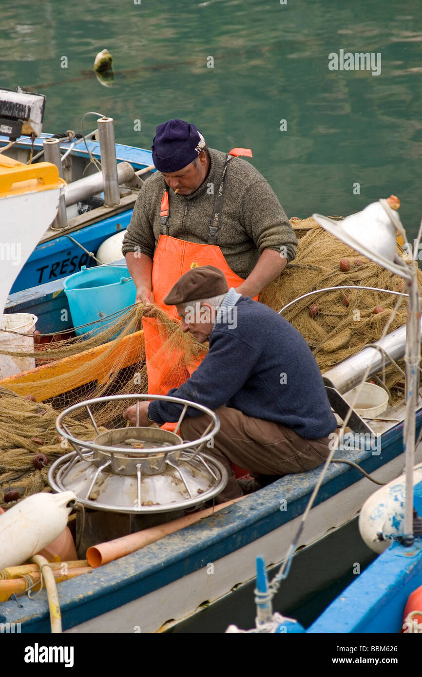 elderly fisherman and boats at harbor Castellammare del Golfo Sicily Italy Stock Photo