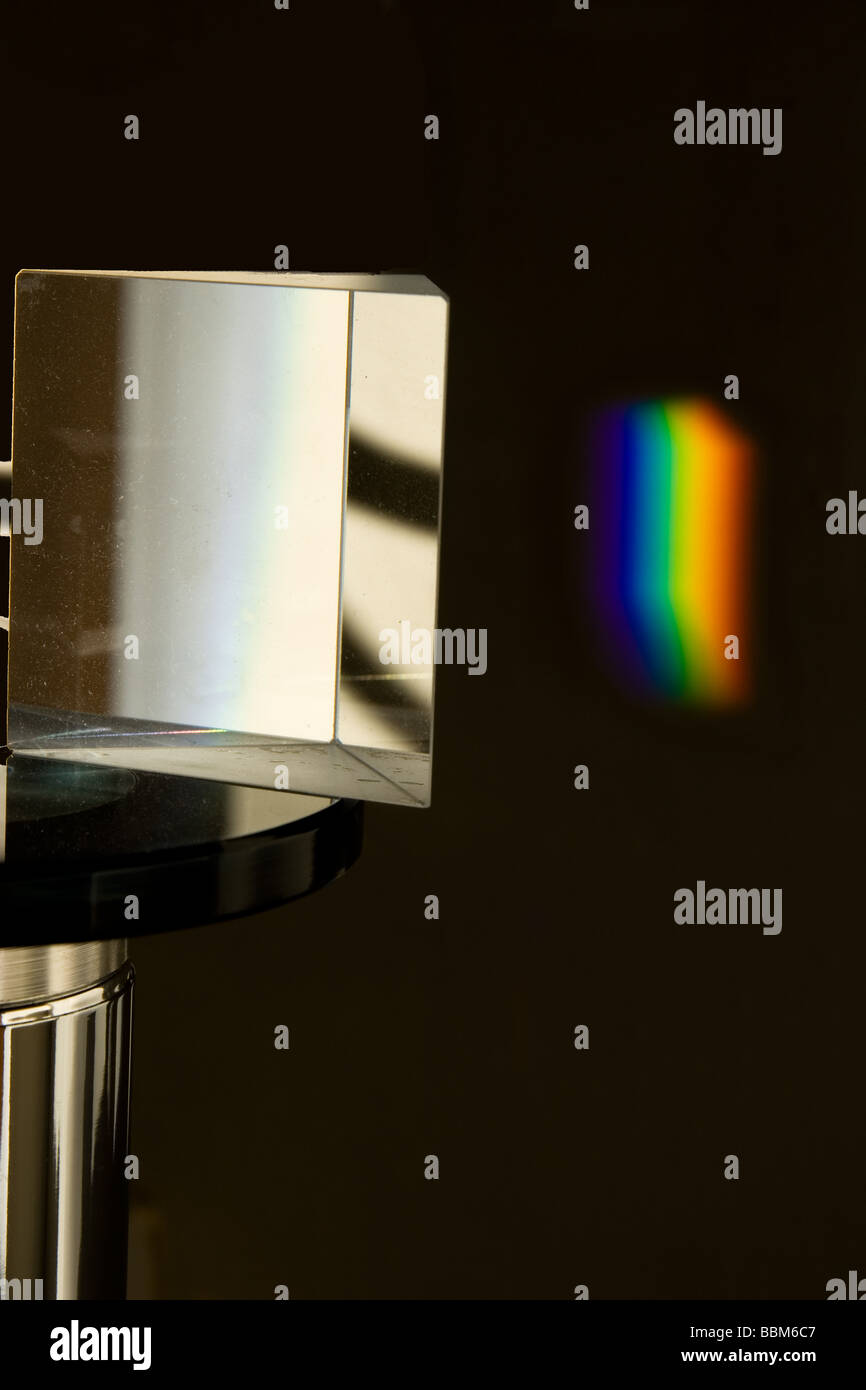 A prism dispersing light into a rainbow Stock Photo