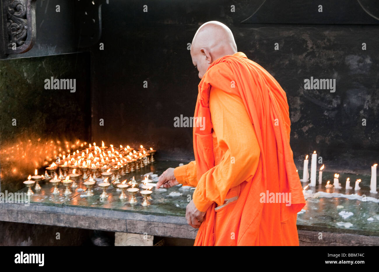 A Buddhist Monk Lighting Candles At Mulgandha Vihar Temple Sarnath Varanasi Uttar Pradesh India Stock Photo