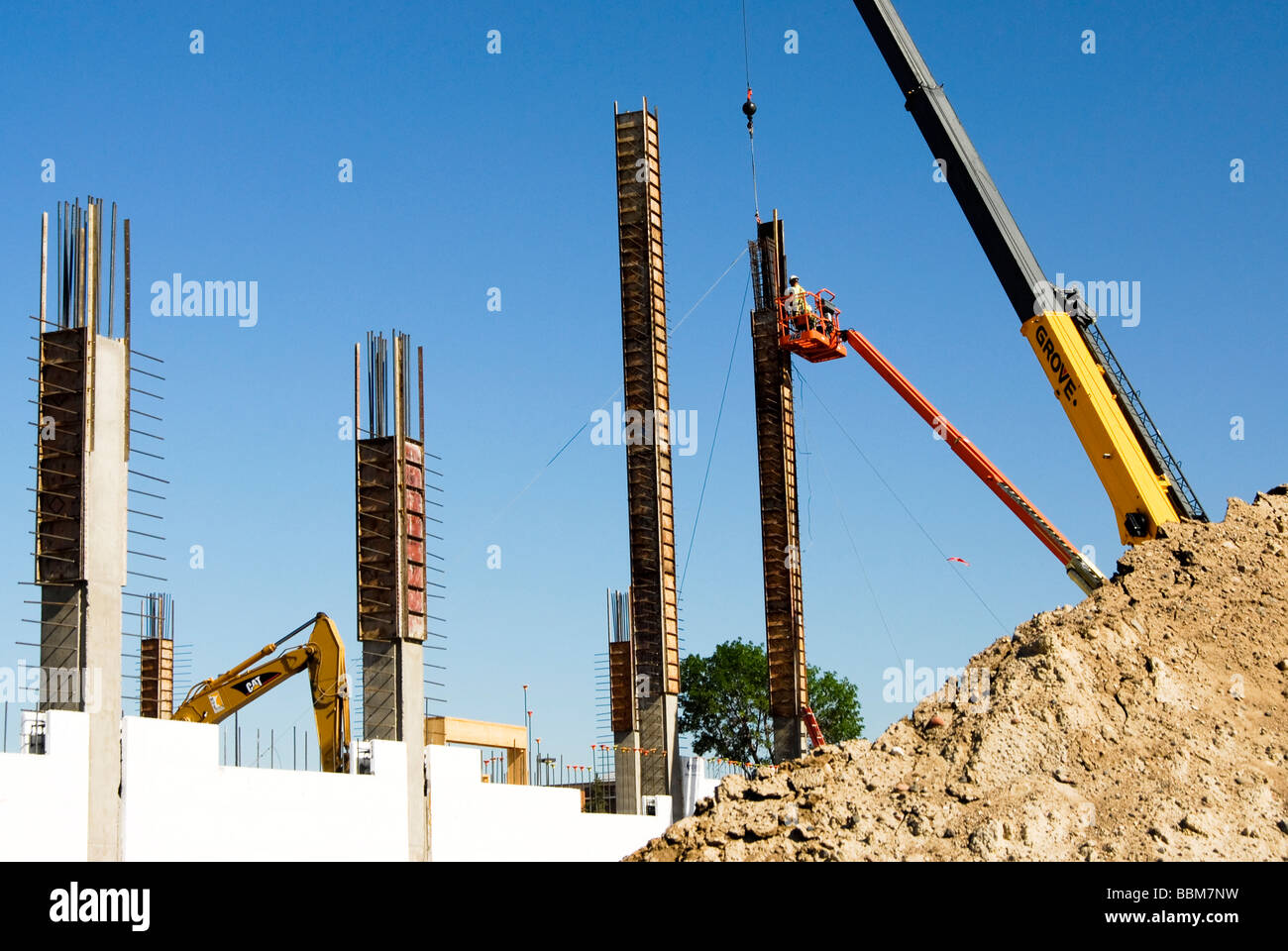 workers assembling forms on a column in a construction site Stock Photo