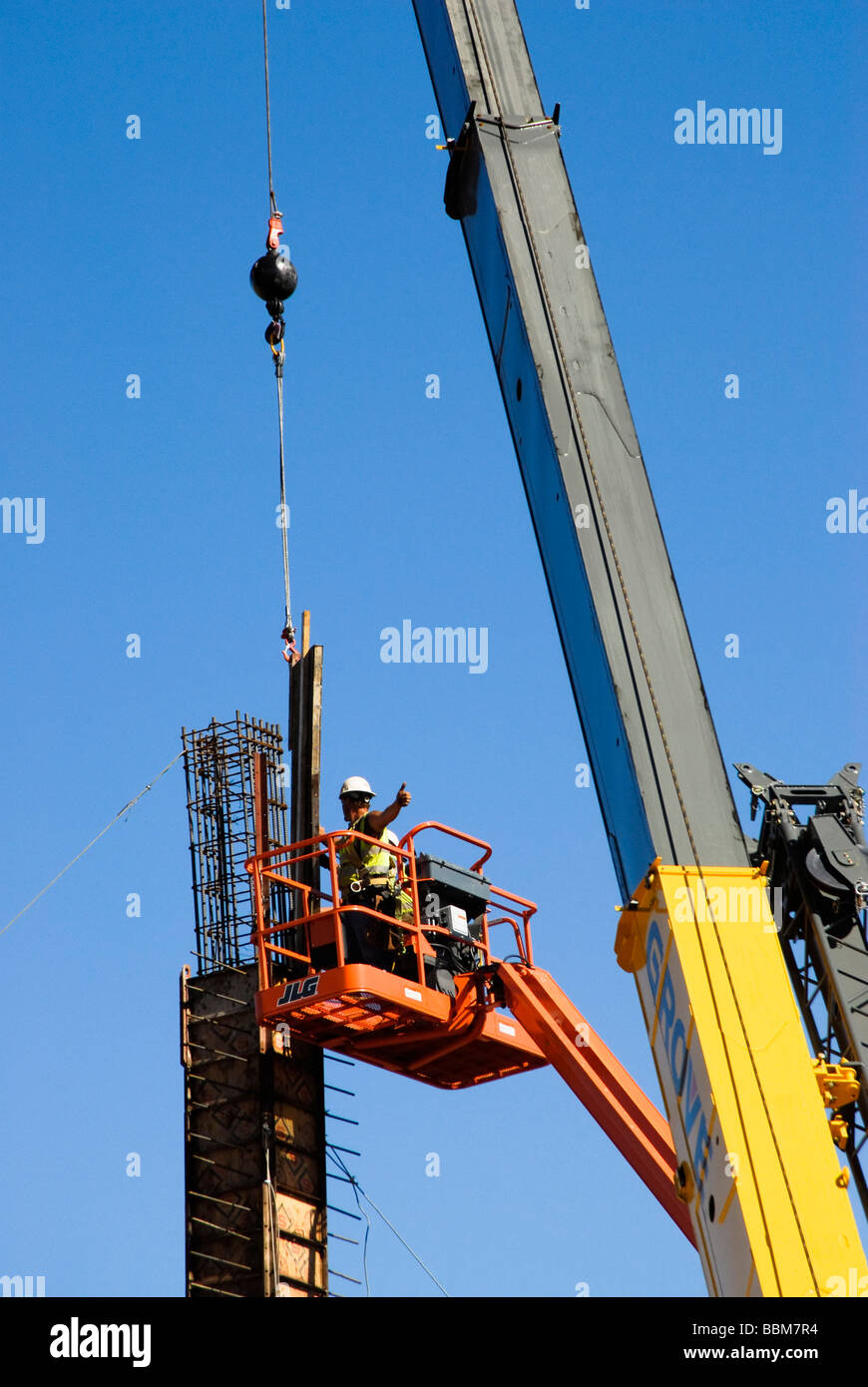 workers assembling forms on a column in a construction site Stock Photo