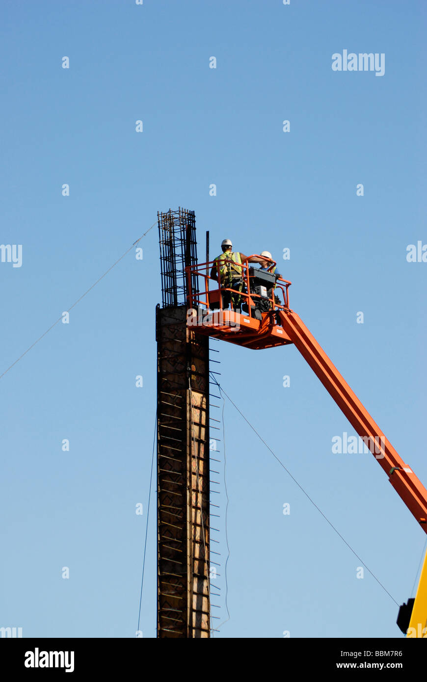 workers assembling forms on a column in a construction site Stock Photo