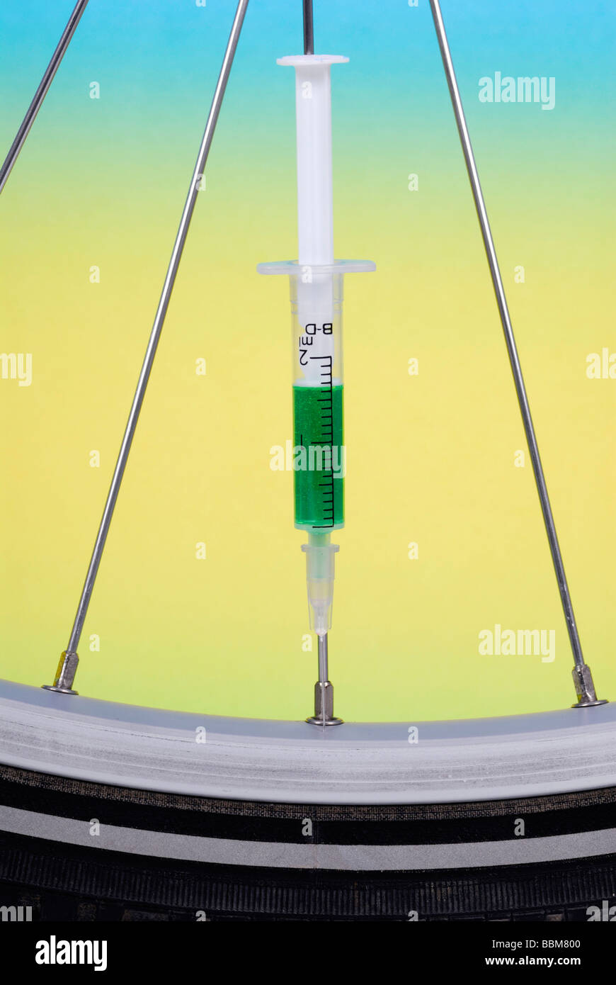 Injection needle in the spoke of a racing cycle tyre, symbolic picture for doping in cycling Stock Photo