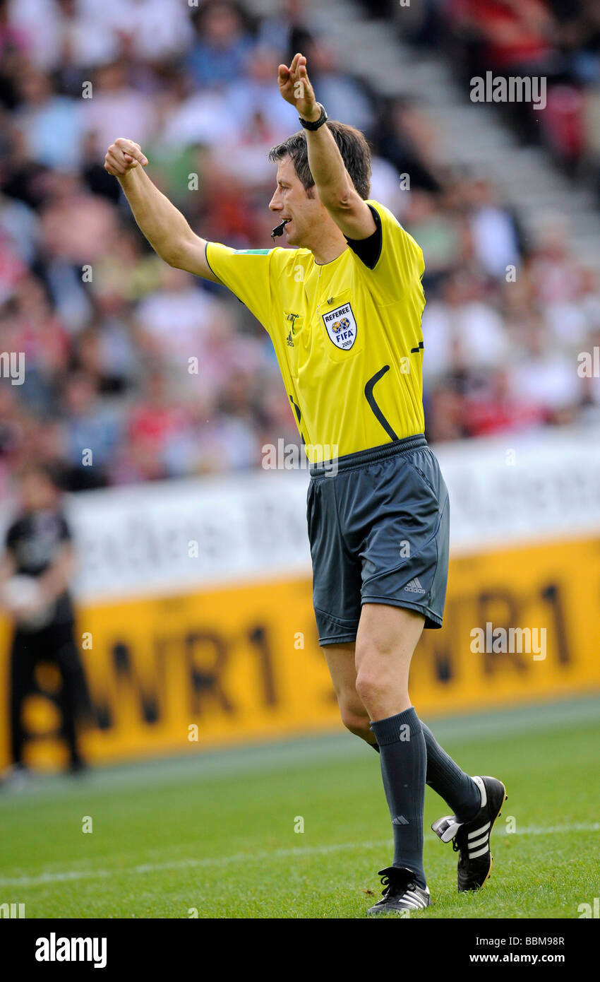 Referee Wolfgang Stark indicating to continue the game Stock Photo