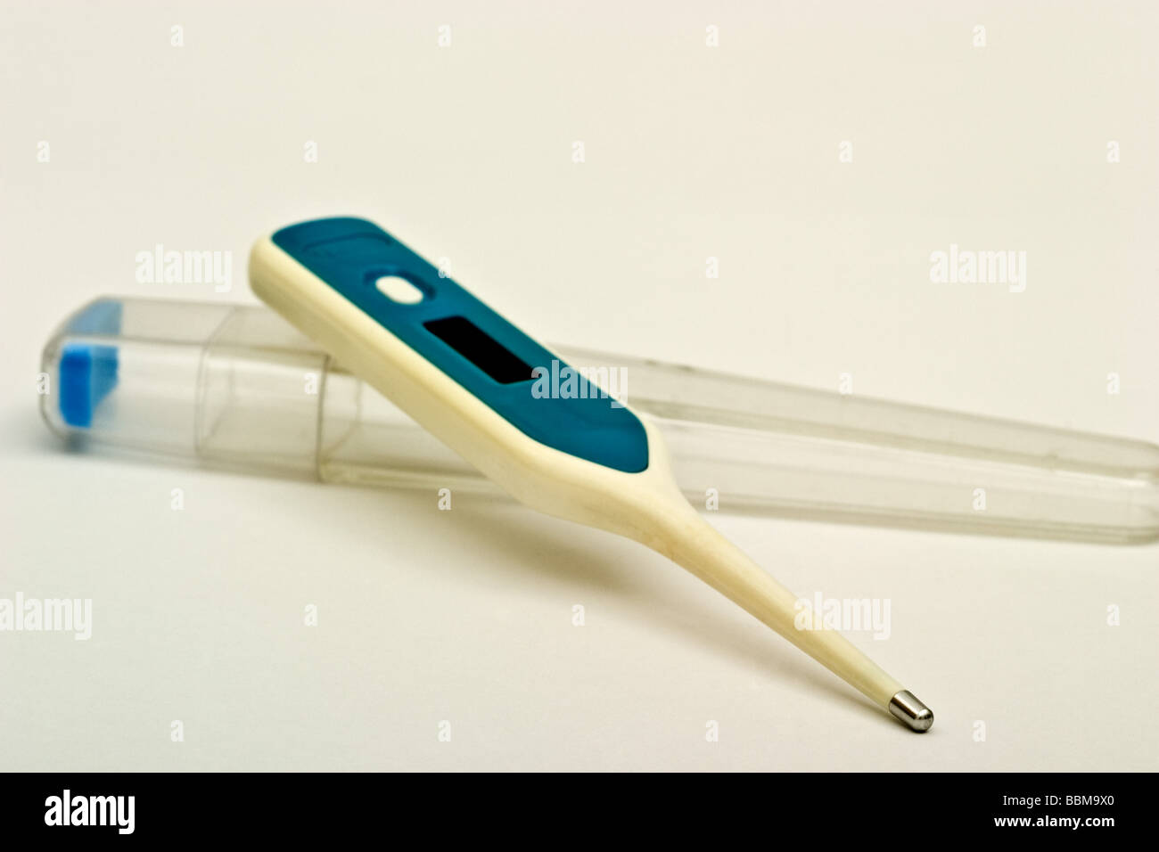 Small digital thermometer on it's plastic case Stock Photo