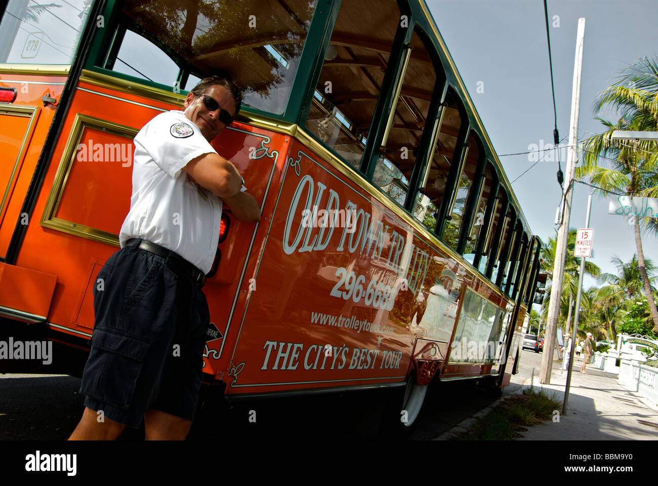 Historic Tours of America guide driver leaning against his open air Old ...