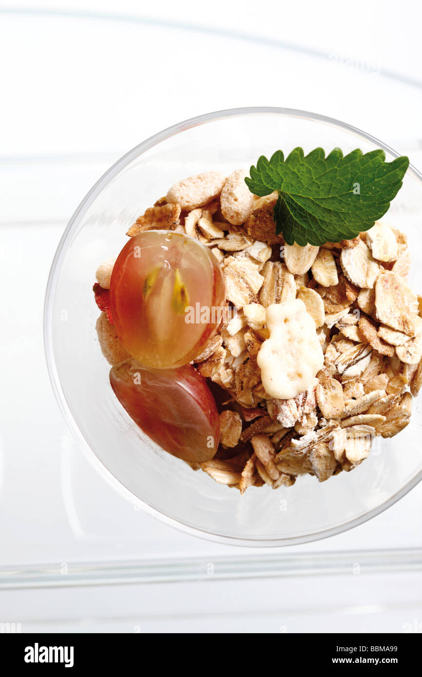 Muesli with grapes in a glass bowl Stock Photo