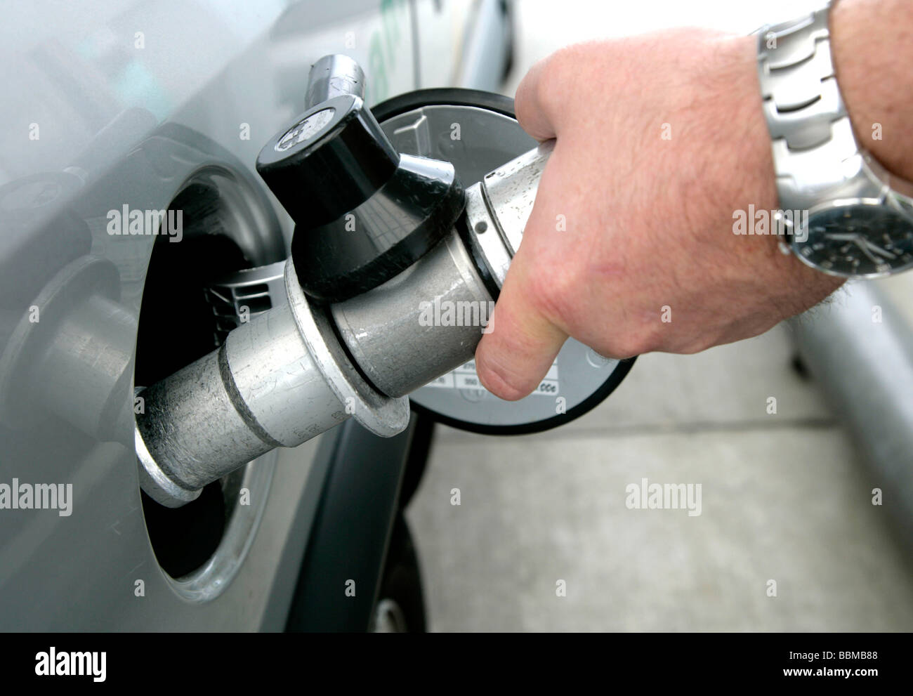 Natural gas filling station, hand holding a fuel nozzle, Forchheim, Bavaria, Germany, Europe Stock Photo