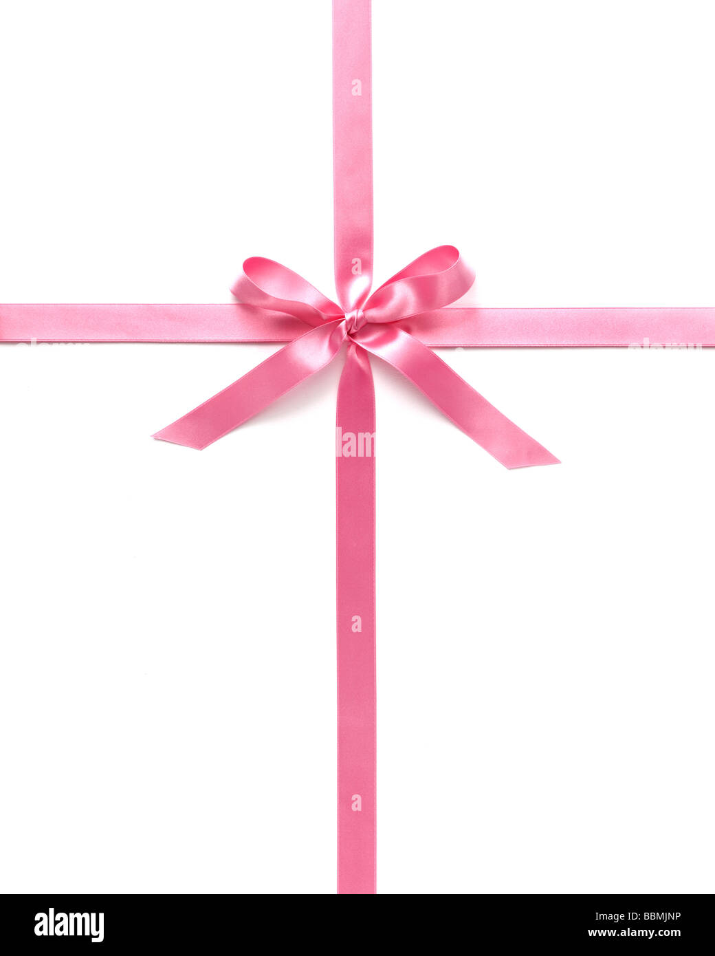 Pink ribbon with bow against white background, close-up Stock Photo