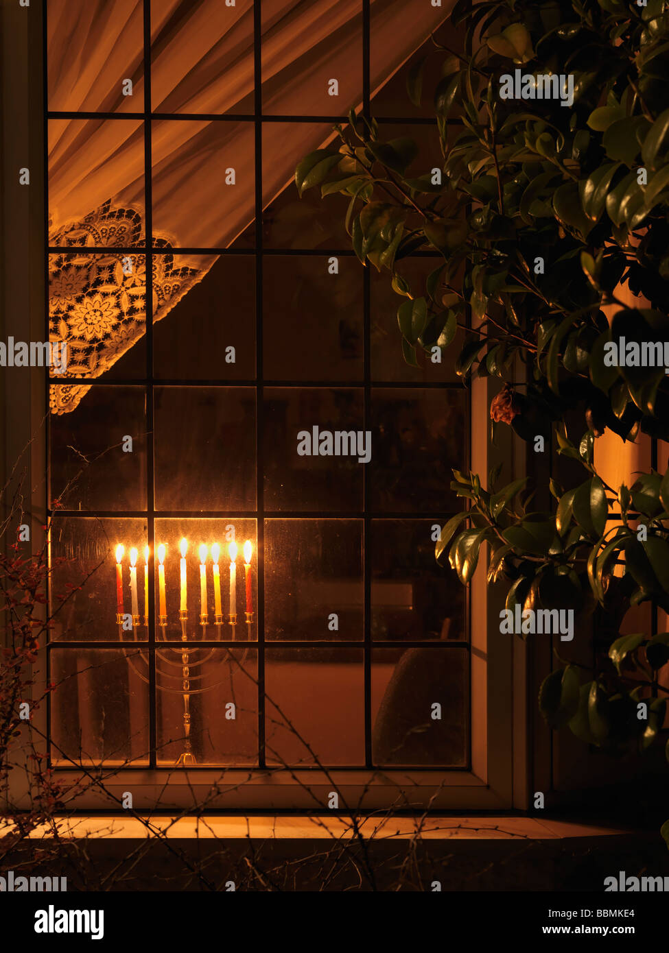 Menorah lit in a Window for Hanukkah the Jewish Festival of Lights