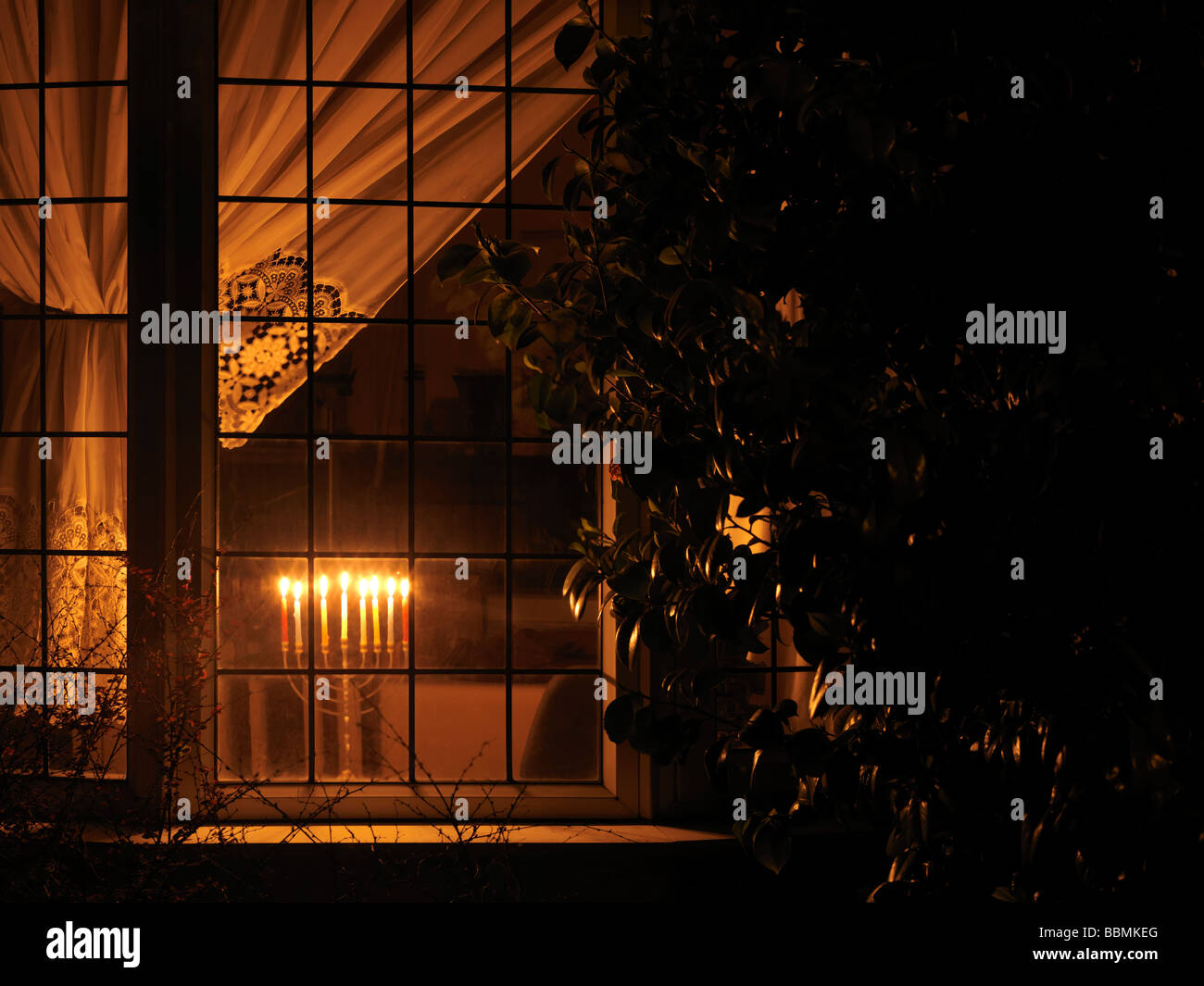 Menorah lit in a Window for Hanukkah the Jewish Festival of Lights