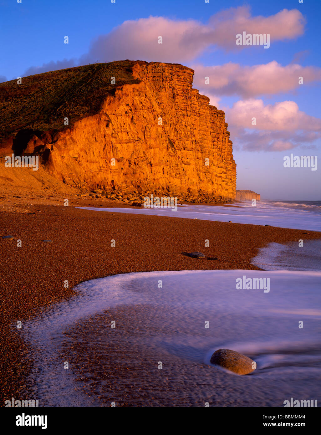 The shingle beach and East Cliff at West Bay near Bridport on the Dorset Jurassic Coast, England. Stock Photo